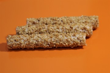 sweet rolls in the nuts on an orange table