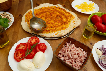 homemade pizza. ingredients, pizza base, tomato sauce