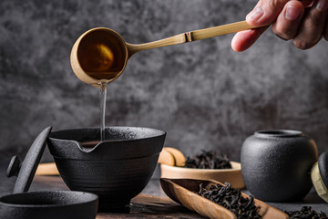 Ceramic tea pot and cups with the famous Photo in the room Chinese tea ceremony on dark background