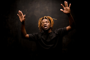African american guy raising up his hands