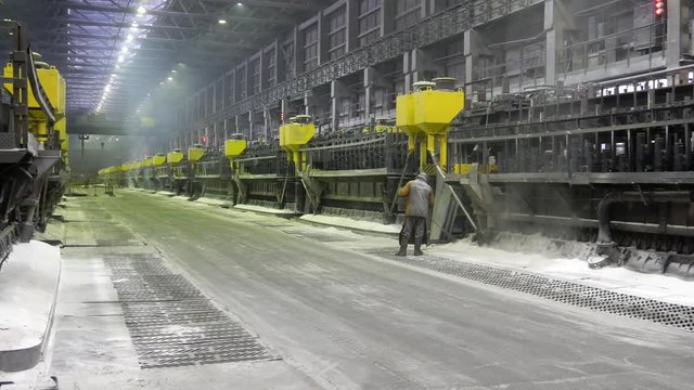 Contemporary large aluminum foundry with casting cells. Electrolytic baths in line in long workshop.