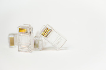 Empty transparent plastic connector rj-45 with eight copper conductors close up isolated on white background. Network connection concept.