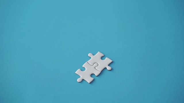 two pieces of jigsaw put together by hand with copy space on left, step of success concept