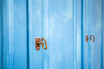 Light blue color wooden doors with rusty keys, vintage design close-up background texture, storage cupboard