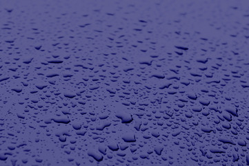 Classic blue color 2020. Texture of water drops on metal. Classic blue background, blue toning 19 4052. Abstract trendy background mock up with copy space for text.