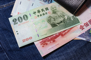 Taiwanese money, Taiwan Banknote, Taiwan dollar on jean background.