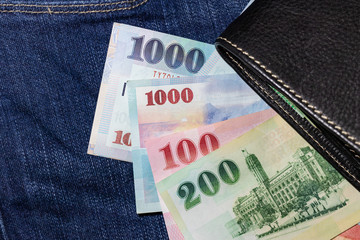 Obraz premium Taiwanese money, Taiwan Banknote, Taiwan dollar on jean background.