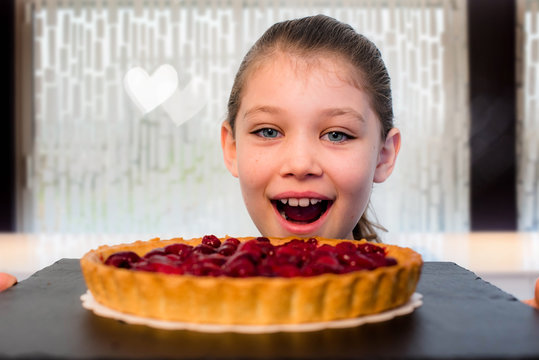 beautiful girl with a big raspberry pie in her hands