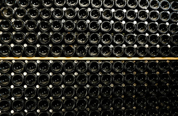 Wine bottles in the cellar. Glass wine bottles. The storage of wine.