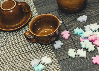 A Cup of coffee with white sugar on a wooden table.