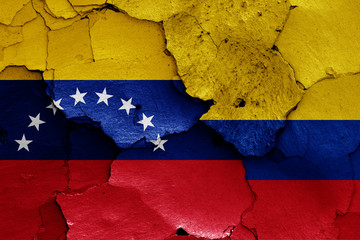 flags of Venezuela and Colombia painted on cracked wall