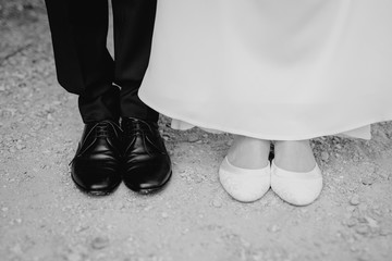 bride and groom showing their shoes