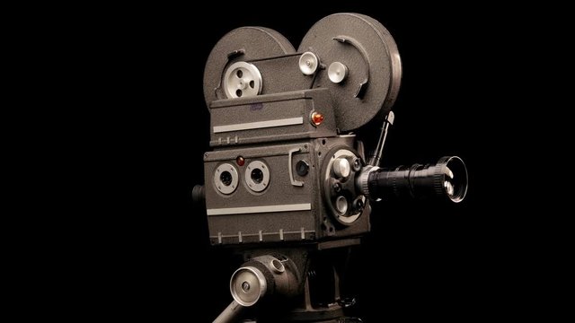 Movie Camera in Front of Black Backdrop.