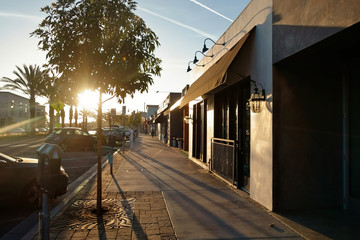 Storefronts along a beach city street.