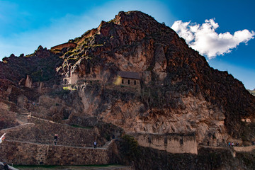 Fototapeta na wymiar Mountain of Ollantaytambo ruins in Cusco with tourists walking.