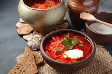 Traditional Ukrainian Russian borscht . Bowl of red beet root soup borsch with white cream . Beet Root delicious soup . Traditional Ukrain food cuisine 