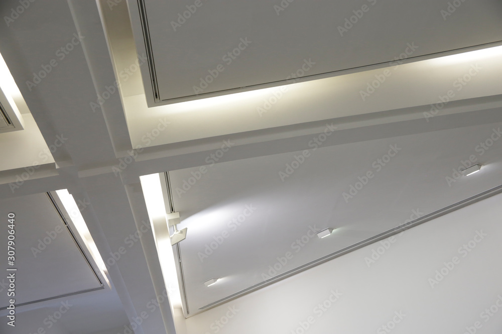 Poster ceiling with backlit girders and lamps. abstract architecture fragment. modern office building inter