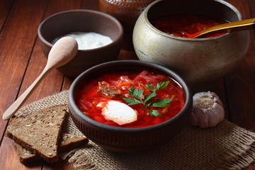 Traditional Ukrainian Russian borscht . Bowl of red beet root soup borsch with white cream . Beet Root delicious soup . Traditional Ukrain food cuisine 