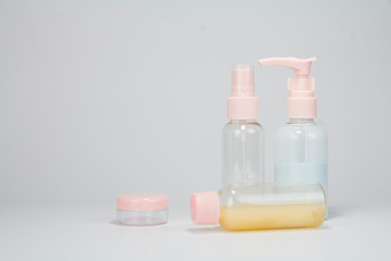 Set of plastic liquid containers for gel, lotion, cream, shampoo, bath foam (transparent). Plastic bottle with dispenser pump, sprayer and jar.