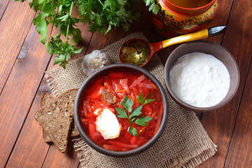 Traditional Ukrainian Russian borscht . Bowl of red beet root soup borsch with white cream . Beet Root delicious soup . Traditional Ukrain food cuisine 