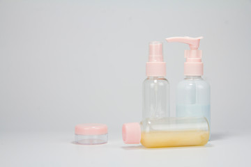 Set of plastic liquid containers for gel, lotion, cream, shampoo, bath foam (transparent). Plastic bottle with dispenser pump, sprayer and jar.