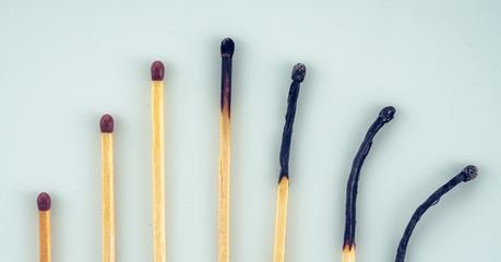 burnt and unburnt matchsticks on white background