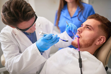 Dentist at work in dental clinic