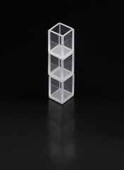 glass chemical containers isolated on black background