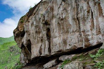 Mountain with rocks and green grass.