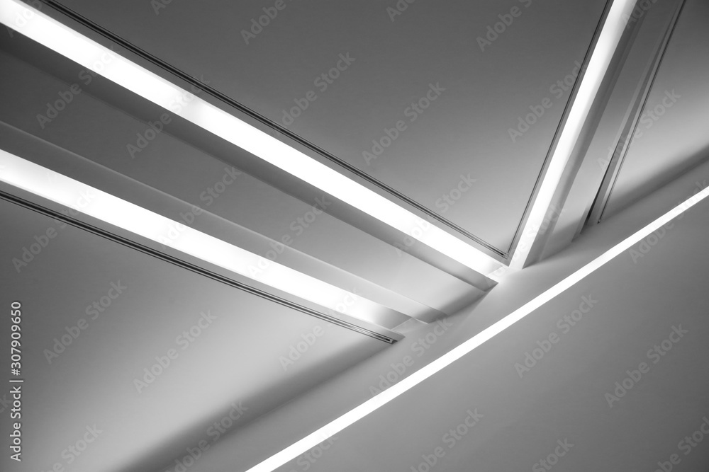 Poster ceiling with backlit girders and lamps. abstract architecture fragment. modern office building inter