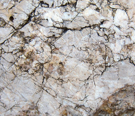 Texture of a sedimentary limestone rock with cracks  