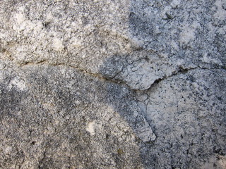 Texture of a sedimentary limestone rock with cracks     