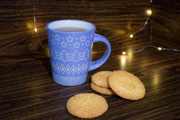 cup of tea and cookies on wooden table