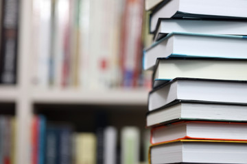 stack of books on bookshelf background, promotion of reading books