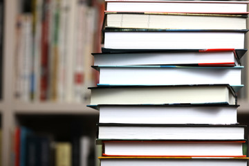 stack of books on bookshelf background, promotion of reading books
