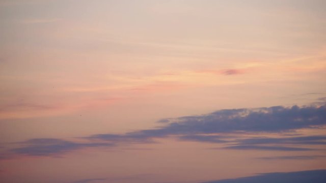 4K Time Lapse. Dramatic sunset. Fast moving pink purple red orange and blue clouds in the sky. Natural colors. Evening sky. Background. TimeLapse Ultra HD stock footage
