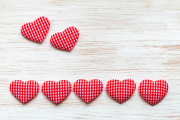 Valentine's day background with red hearts on wooden planks. Valentine's Day concept