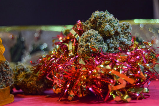 dried cannabis flowers with christmas decorations to celebrate the new year