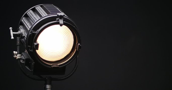Vintage Theatre Stage Spotlight  Slowly Turn On and Off. Black Background. Lens Flare.