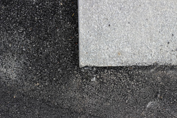 Fototapeta premium Dark new asphalt surface surrounding marble tile detail texture 