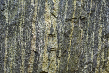 Green stone textured wall background with roughness and irregularities.