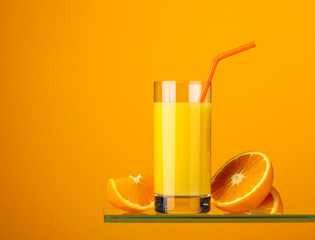 Glass of fresh orange juice with fresh fruits.