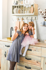 mom and her daughter light the sparklers together and prepare for the New Year celebration