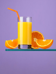 Glass of fresh orange juice with fresh fruits.