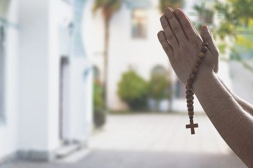 Religious Asian buddhist woman praying, chanting mantra to the lord Buddha with buddhist style rosary beads in hand