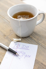 Cup of hot tea on a desk from above