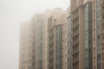 Part of a multistory building in the morning mist. Contemporary typical dwelling.