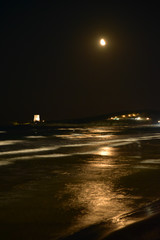 Night Seascape by Summer with Moon in the Sky in Vieste, Italy
