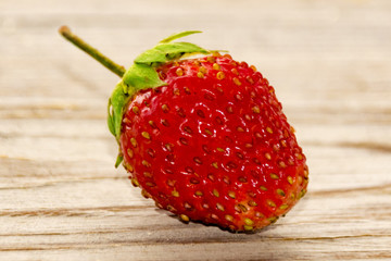one strawberries on a wooden background  real nature