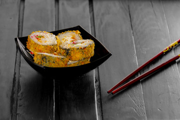 rolls in a black plate on black Board sticks